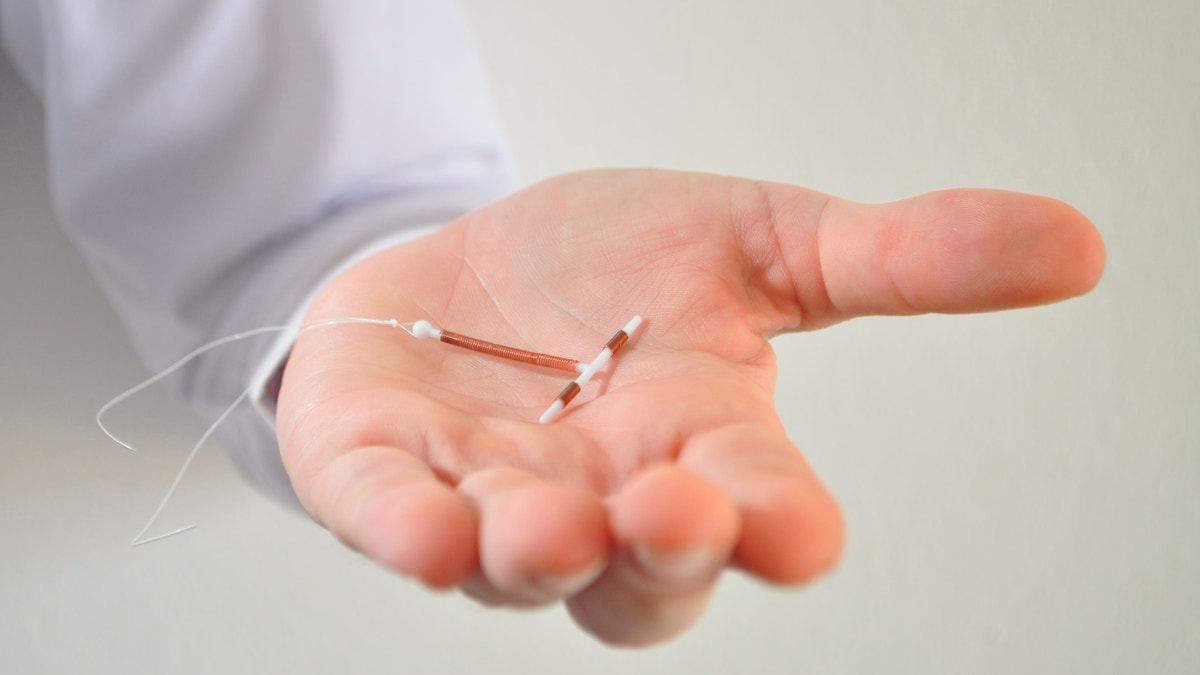 doctor holding an IUD istock large