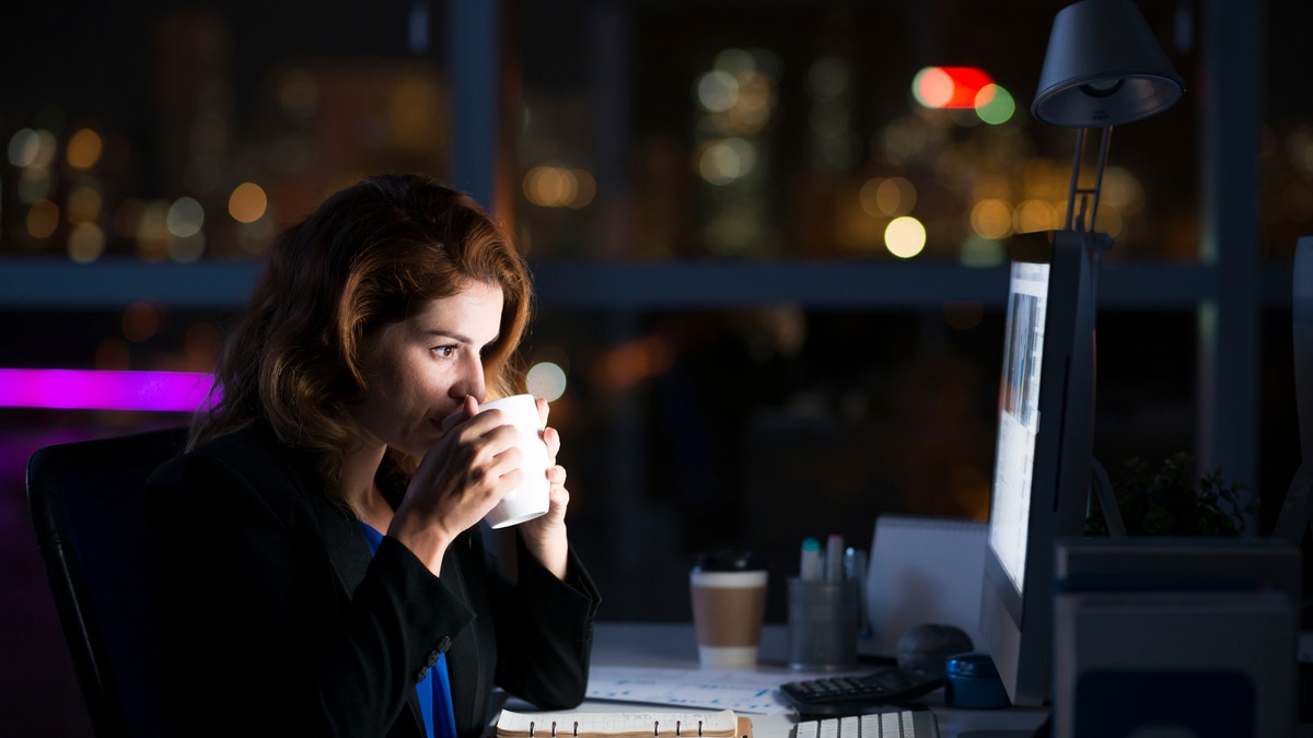 drinking coffee at work working overtime working late istock large