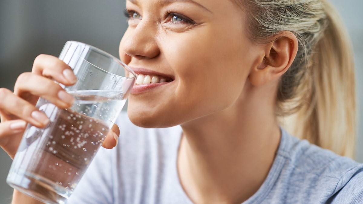 Young woman drinking water