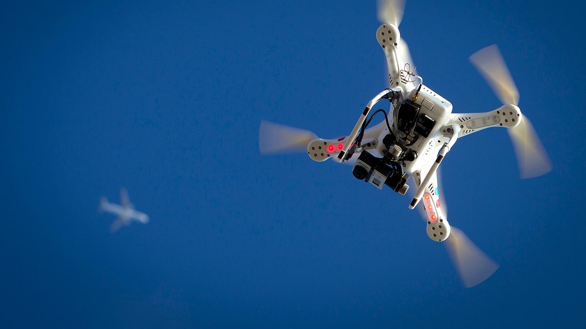 An airplane flies over a drone during the Polar Bear Plunge on Coney Island in the Brooklyn borough of New York January 1, 2015. The Coney Island Polar Bear Club is one of the oldest winter bathing organizations in the United States and holds a New Year's Day plunge every year.     REUTERS/Carlo Allegri   (UNITED STATES - Tags: SOCIETY ANNIVERSARY) - RTR4JUL7