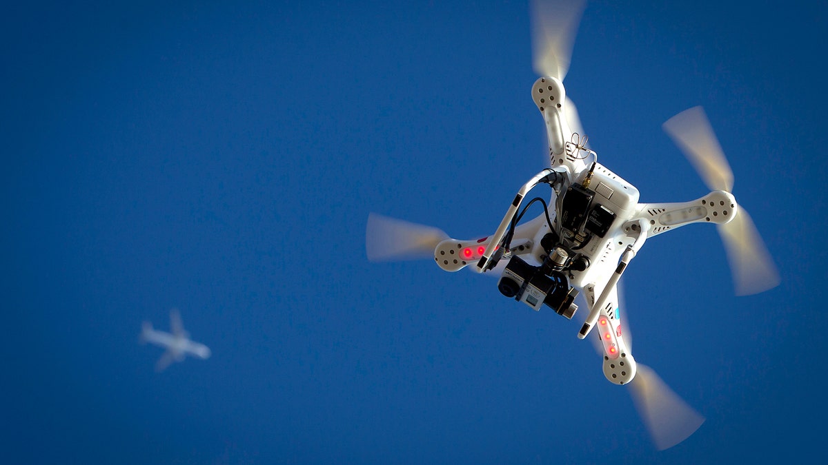 An airplane flies over a drone during the Polar Bear Plunge on Coney Island in the Brooklyn borough of New York January 1, 2015. The Coney Island Polar Bear Club is one of the oldest winter bathing organizations in the United States and holds a New Year's Day plunge every year.     REUTERS/Carlo Allegri   (UNITED STATES - Tags: SOCIETY ANNIVERSARY) - RTR4JUL7