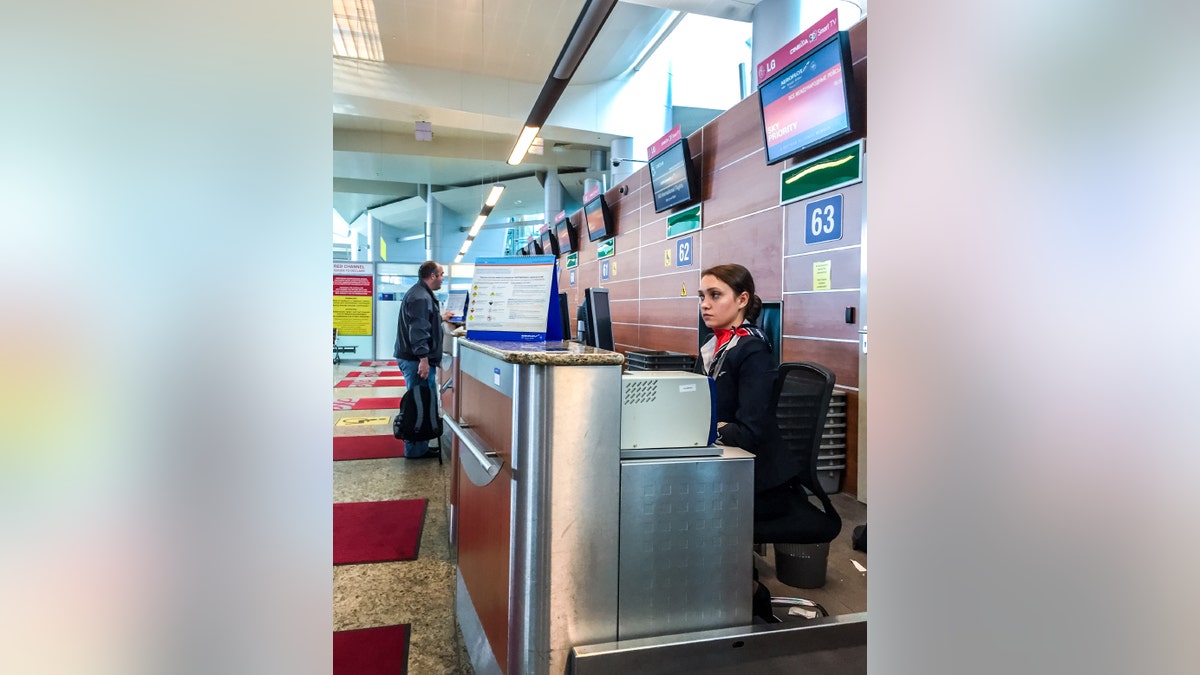 Airport Check-in Attendant waiting for passengers