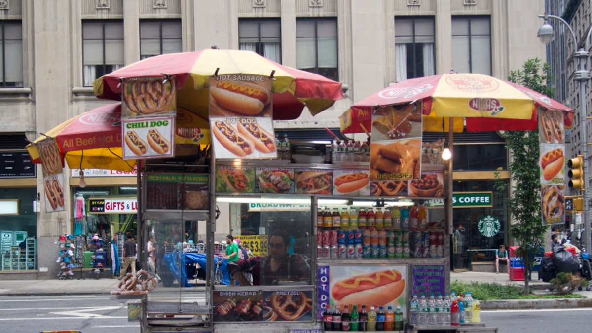 Vendor selling hot dogs and other snack foods in NYC
