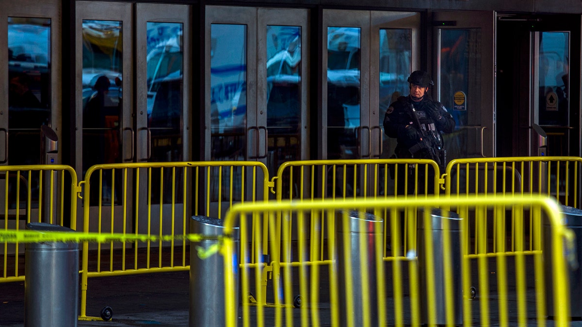 A police officer stands guard in front of Port Authority Bus Terminal as law enforcement respond to a report of an explosion near Times Square on Monday, Dec. 11, 2017, in New York. (AP Photo/Andres Kudacki)