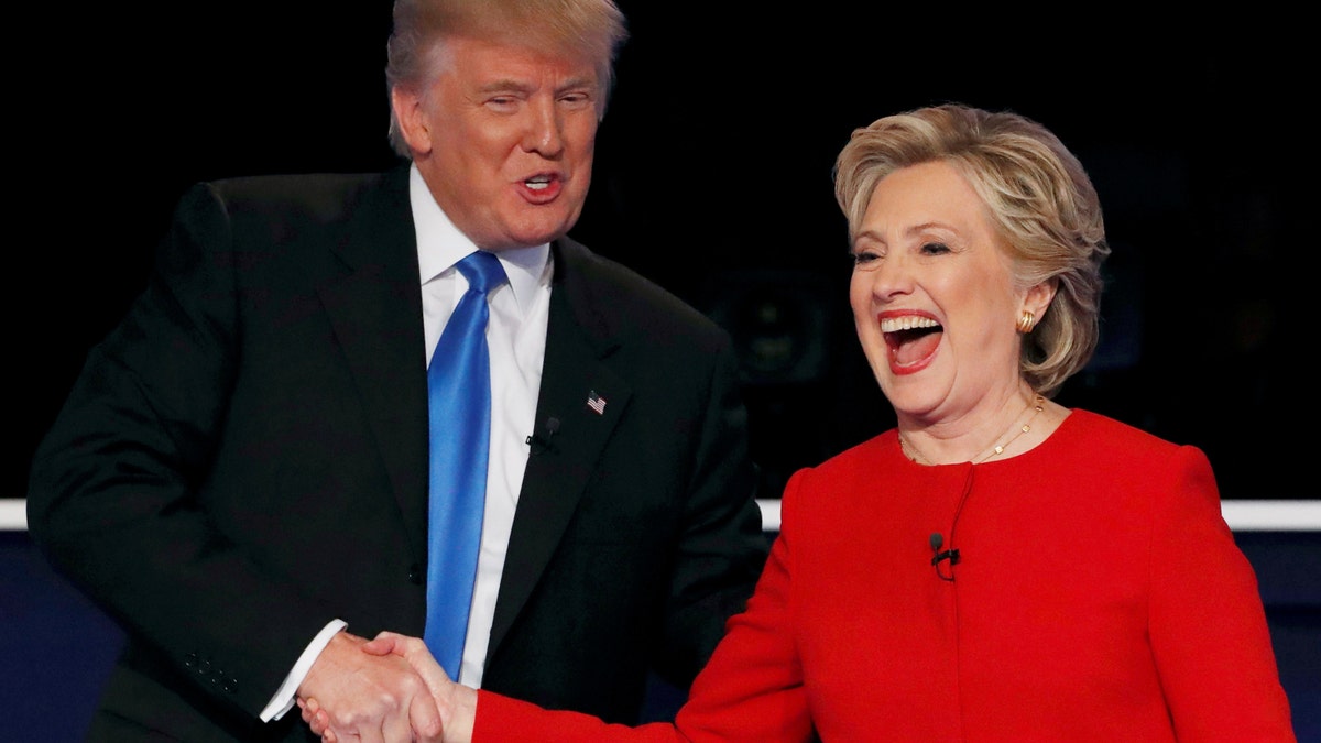 Republican U.S. presidential nominee Donald Trump shakes hands with Democratic U.S. presidential nominee Hillary Clinton at the conclusion of their first presidential debate at Hofstra University in Hempstead, New York, U.S., September 26, 2016. REUTERS/Mike Segar/File Photo - RTX2S3QH