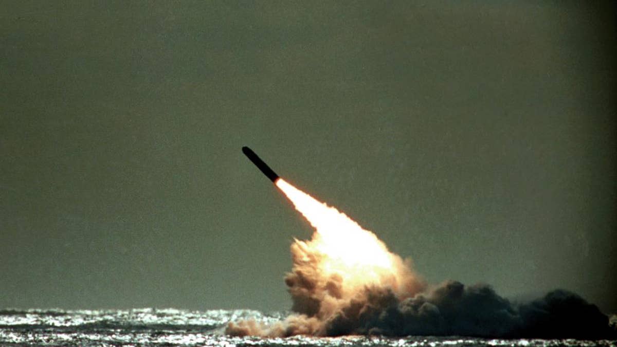 FILE - In this file photo dated Monday, Dec. 4, 1989, a Trident II missile launched by the U.S. Navy during a performance evaluation from the submerged submarine USS Tennessee in the Atlantic Ocean off the coast of Cape Canaveral in Titusville, Fla., USA. According to Britain's Sunday Times newspaper published Sunday Jan. 22, 2017, an unarmed nuclear test missile fired by a British submarine off the coast of Florida in 2016, misfired and the failure was allegedly covered up ahead of a debate in Parliament on the future of the Trident missile system. British Prime Minister Theresa May has refused to say whether she knew about the reported failure. (AP Photo/Phil Sandlin, FILE)