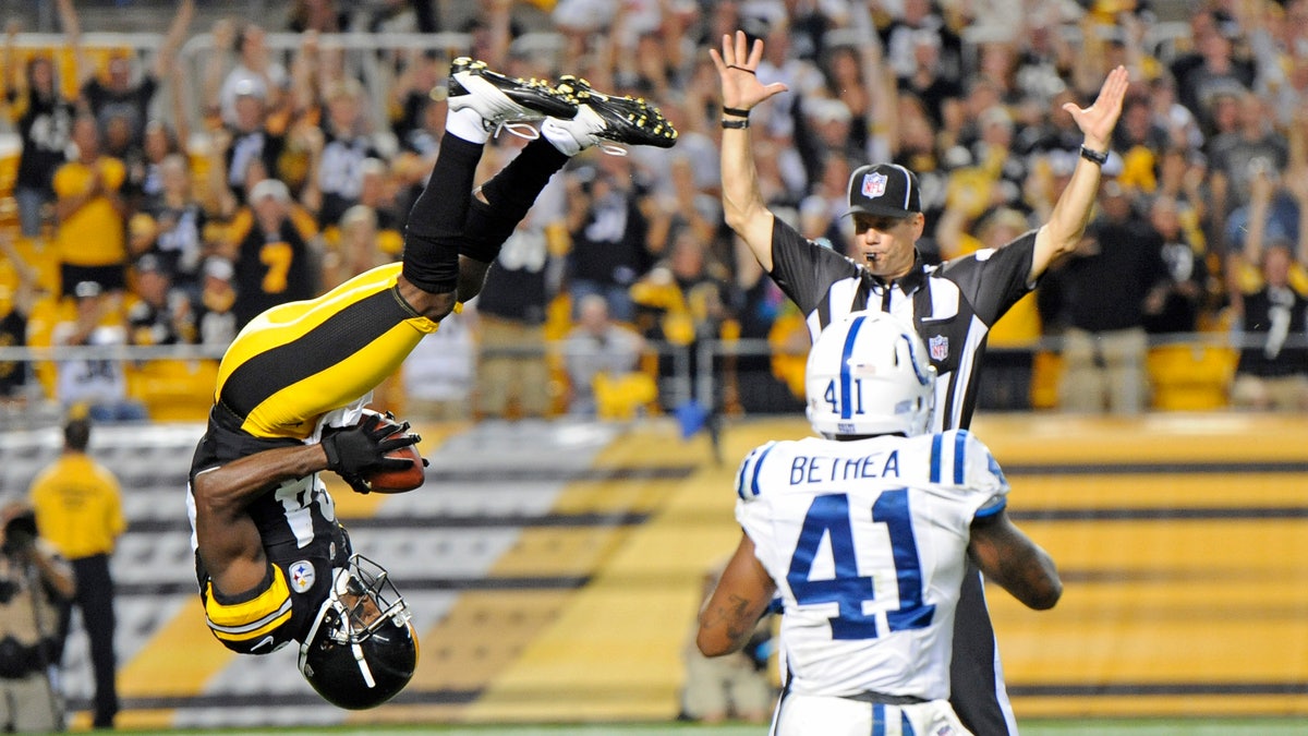 Pittsburgh Steelers wide receiver Antonio Brown (84), left, flips into the end zone over Indianapolis Colts defensive back Antoine Bethea (41) for a touchdown in the first quarter of an NFL football preseason game on Sunday, Aug. 19, 2012 in Pittsburgh. (AP Photo/Don Wright)