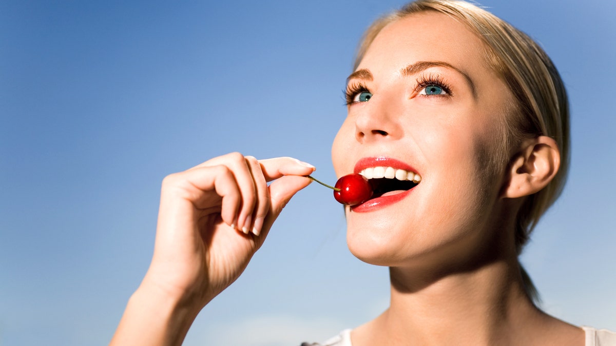 woman eating cherry