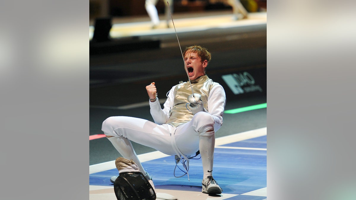 Race Imboden, of the United States, celebrates after winning a men's individual foil round 8 qualifying match against Germany's Peter Joppich at the World Fencing Championship in Catania, Italy, Thursday, Oct. 13, 2011. (AP Photo/Carmelo Imbesi)