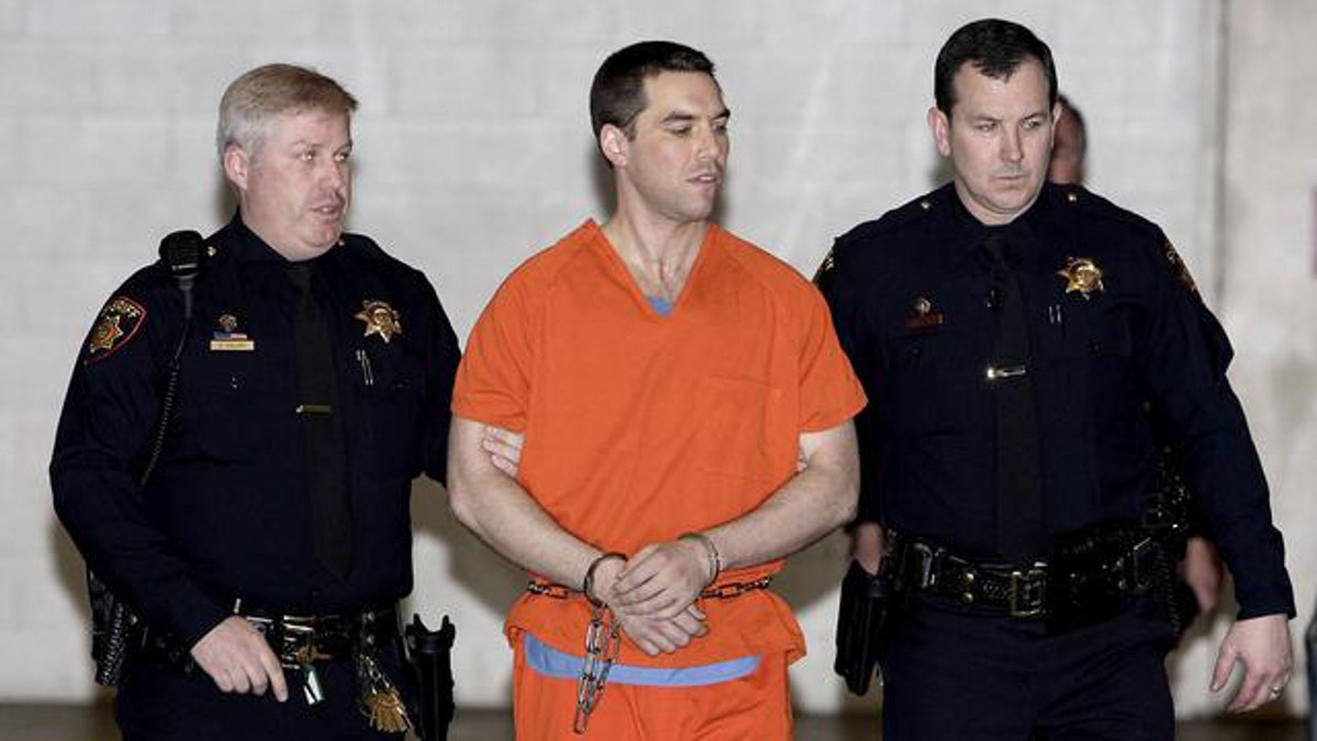 Scott Peterson is escorted by two San Mateo County Sheriff deputies as he is walked from the jail to a waiting van Thursday, March 17, 2005, in Redwood City, Calif. Peterson was taken to death row at San Quentin State Prison early Thursday after being sentenced to die for murdering his pregnant wife, Laci. (AP Photo/Justin Sullivan, Pool) 