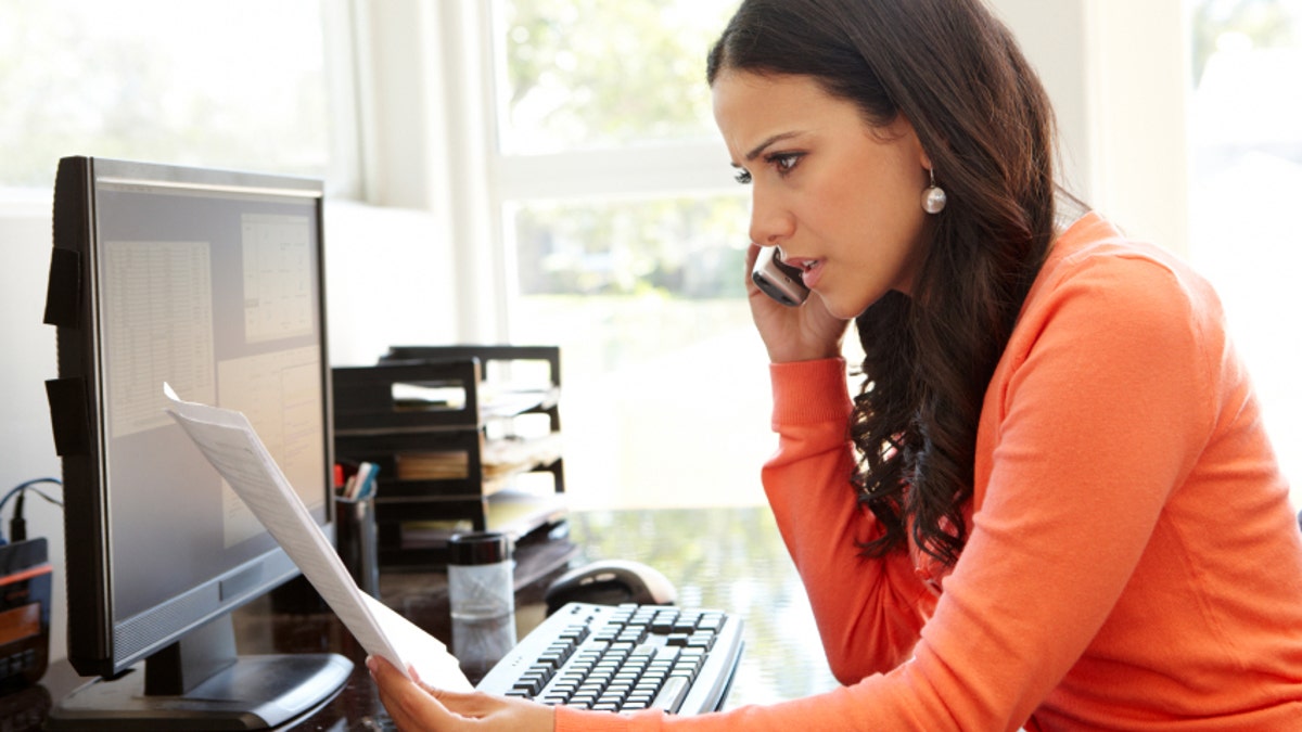 Hispanic woman working in home office