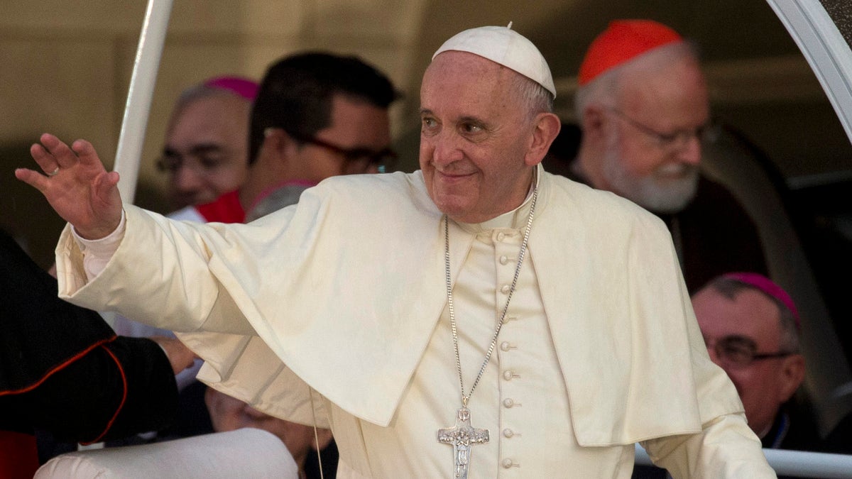 Pope Francis leaves after a meeting with a group of Cuban youth in Havana, Cuba, Sunday Sept. 20, 2015. Pope Francis met with Fidel Castro on Sunday before finishing the day with a vespers service in Havana's cathedral, and a meeting with the youths. In the background at right is Cardinal Sean Patrick O'Malley. (AP Photo/Ramon Espinosa)