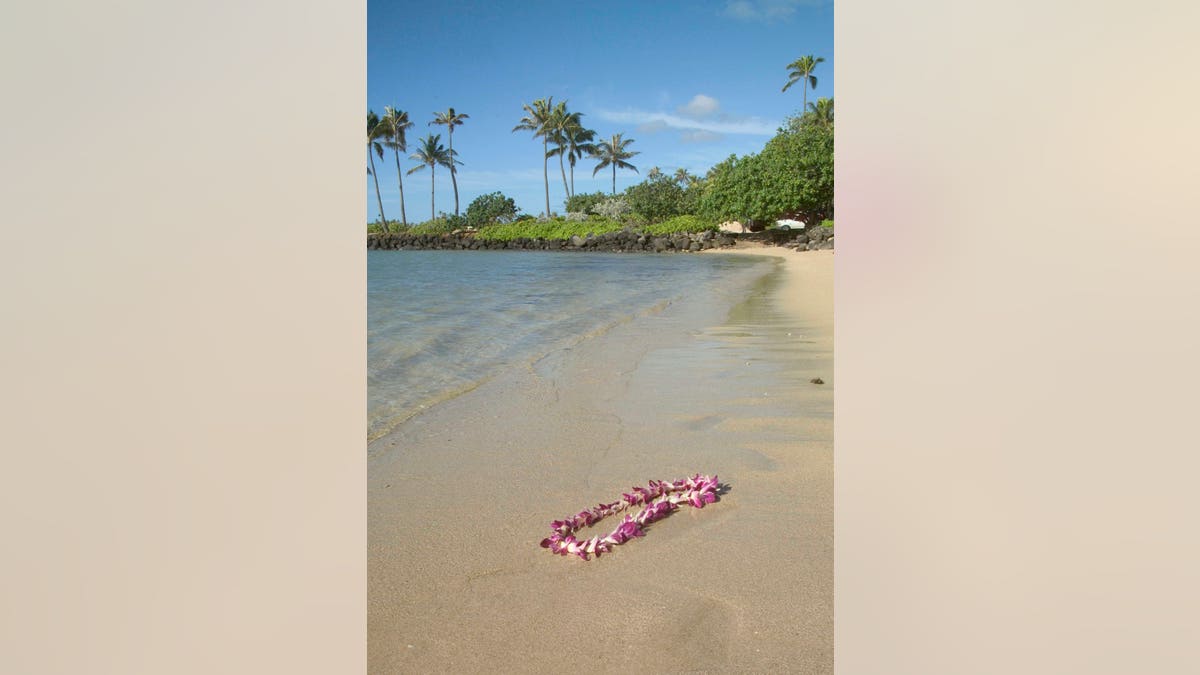 Garland of flowers on sand