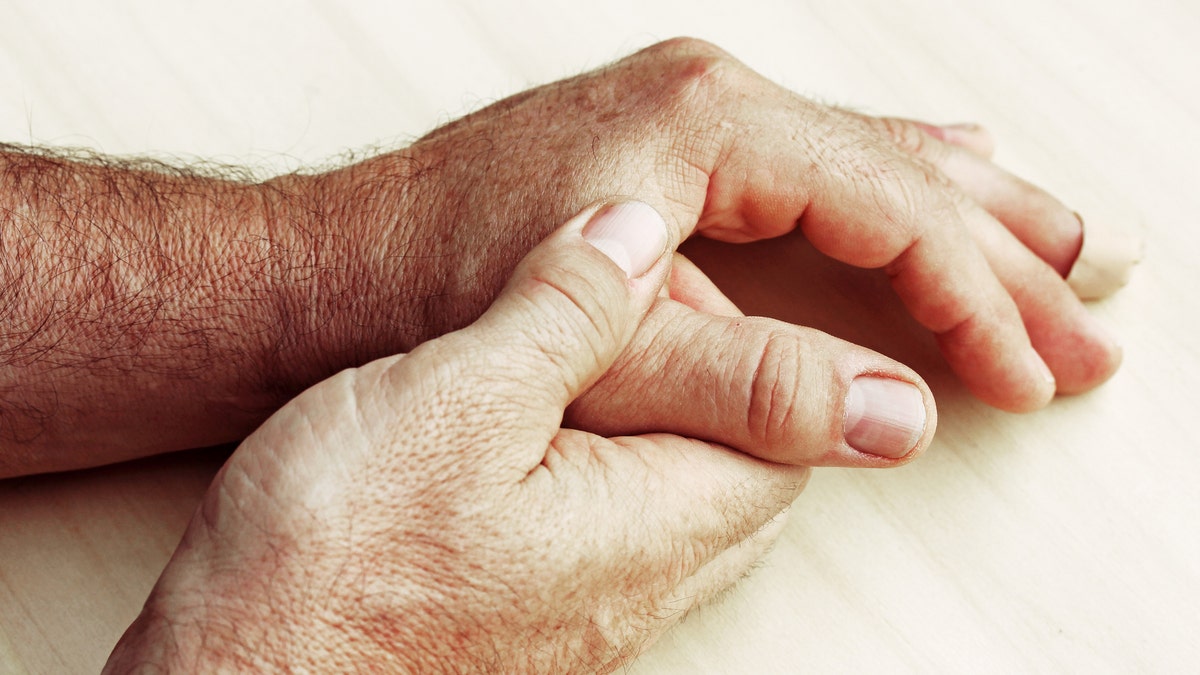 elderly man hand pain gout istock large