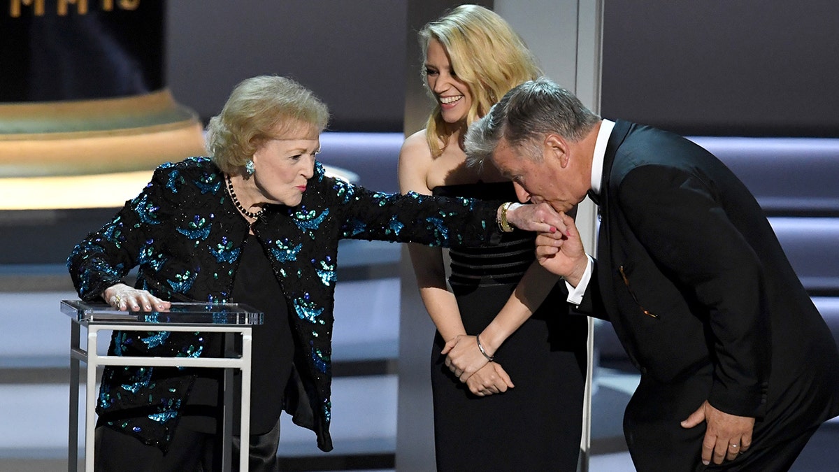 LOS ANGELES, CA - SEPTEMBER 17: (L-R) Betty White, Kate McKinnon, and Alec Baldwin speak onstage during the 70th Emmy Awards at Microsoft Theater on September 17, 2018 in Los Angeles, California. (Photo by Kevin Winter/Getty Images)