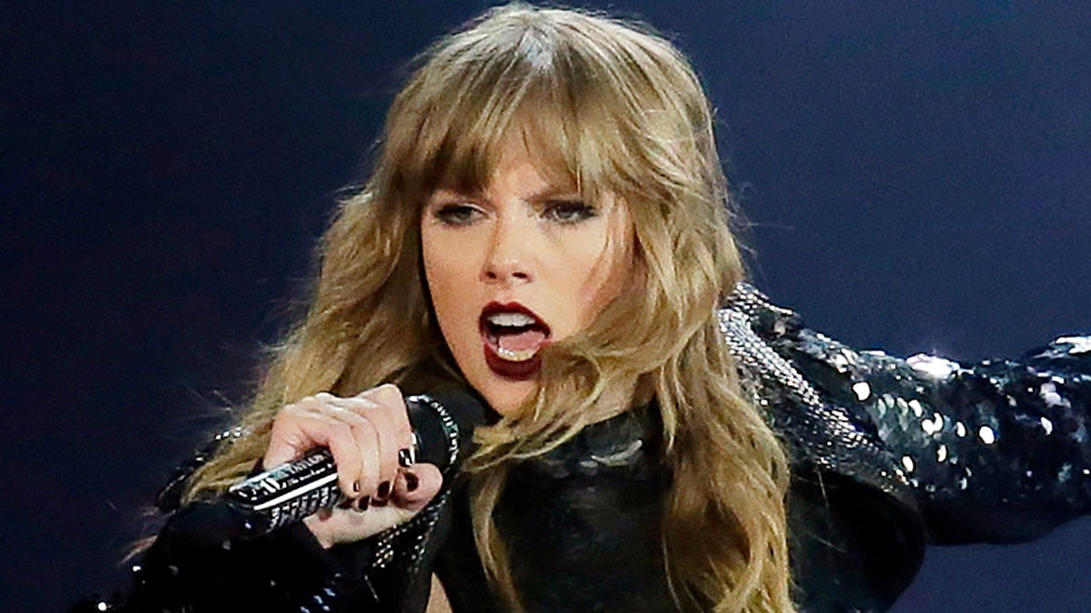 Taylor Swift singing into microphone