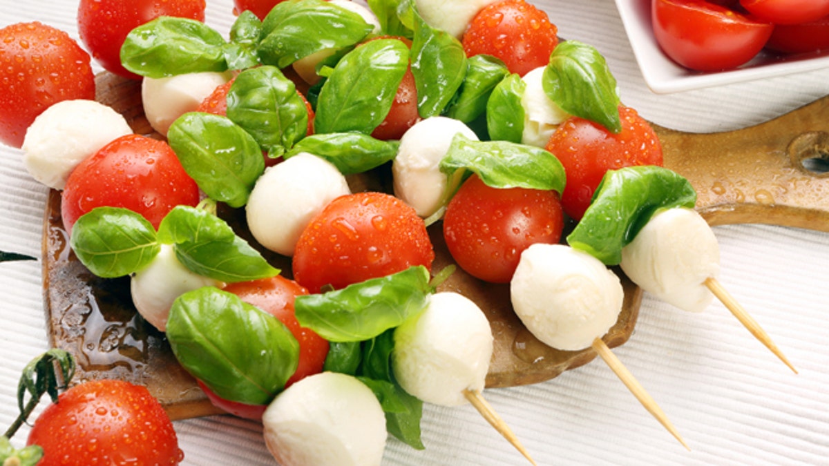 Caprese salad. Skewers with tomato and mozzarella with basil