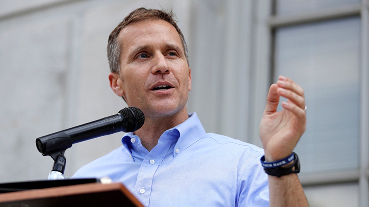 FILE- In this May 23, 2017, file photo, Missouri Gov. Eric Greitens speaks to supporters during a rally outside the state Capitol in Jefferson City, Mo. Some fellow Republican lawmakers are raising questions about whether GOP Gov. Eric Greitens had the authority to increase funding for foster-care families above what legislators budgeted. House Budget Committee Chairman Scott Fitzpatrick says the governor's action was an unconstitutional overstep of his powers. (AP Photo/Jeff Roberson, File)