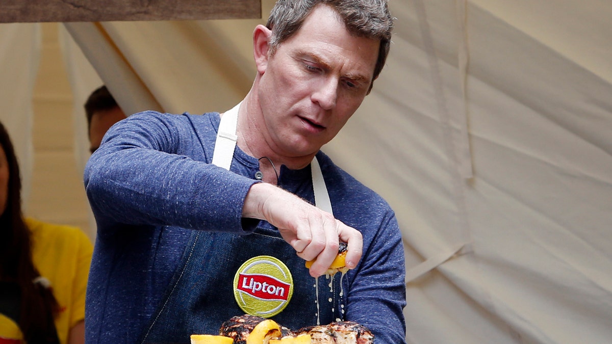 Chef Bobby Flay turned âhead counselorâ demonstrates how to make delicious summer dishes using Lipton Iced Tea at Lipton Summer Camp on Thursday, June 8, 2017, in New York. The event gave people a chance to re-live their favorite summertime memories right in Herald Square. For more information on the recipes and to learn how you could enter for a once-in-a-lifetime Food Network Star experience to dine with Bobby Flay visit www.liptonmeal.com. (Jason DeCrow/AP Images for Lipton)