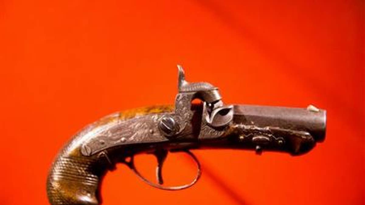 In this March 17, 2015, file photo, John Wilkes Booth's pistol used to kill President Abraham Lincoln is displayed at a new exhibit at the Ford's Center for Education and Leadership.