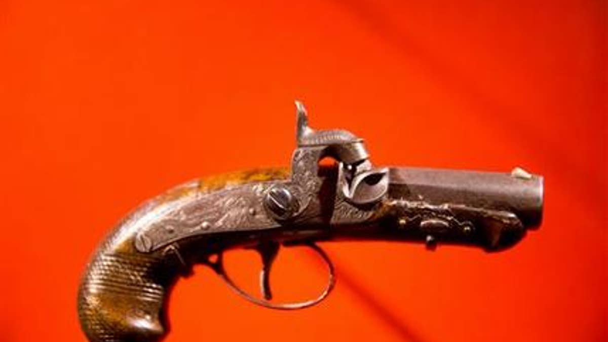 In this March 17, 2015, file photo, John Wilkes Booth's pistol used to kill President Abraham Lincoln is displayed at a new exhibit at the Ford's Center for Education and Leadership.