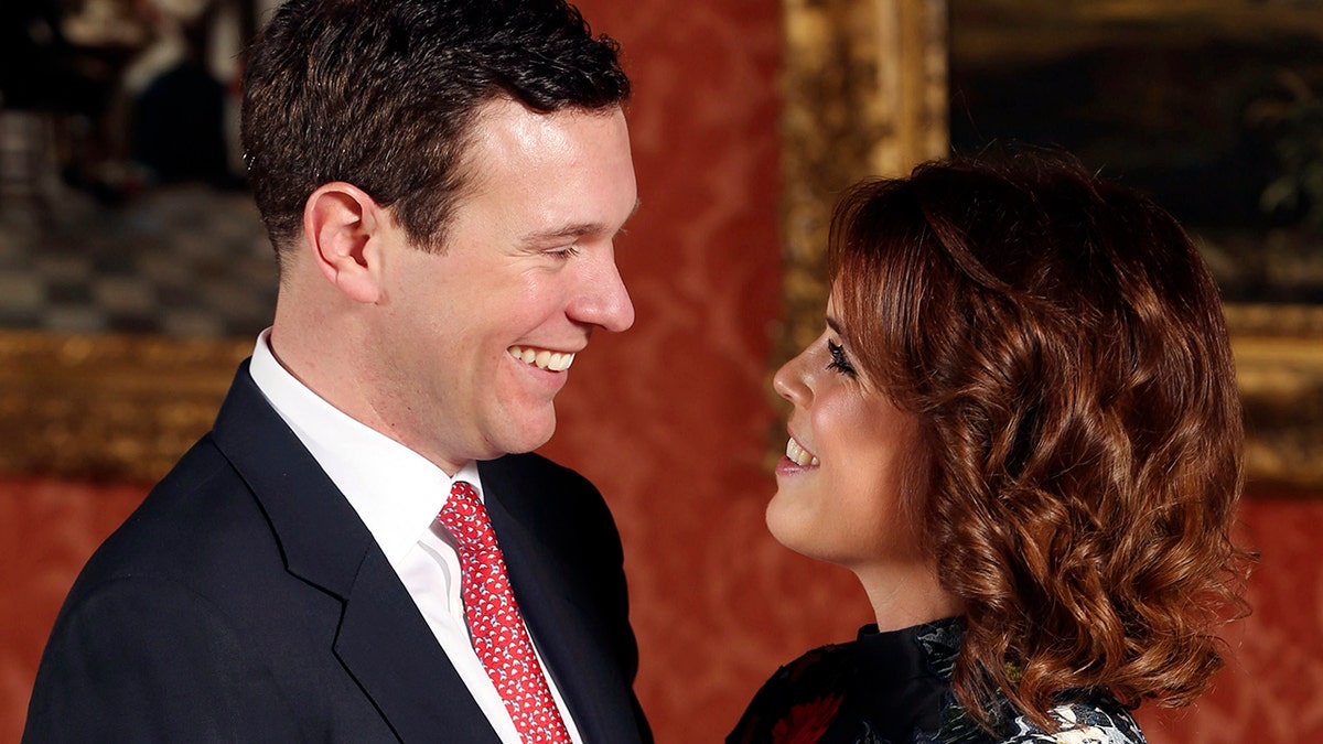Britain's Princess Eugenie and Jack Brooksbank pose for the media in the Picture Gallery at Buckingham Palace after they announced their engagement in London, Monday, Jan. 22, 2018. Princess Eugenie is engaged to be married later this year, several months after her cousin Prince Harry's nuptials. Eugenie, the daughter of Prince Andrew and his ex-wife Sarah Ferguson, will marry Jack Brooksbank in the fall, Buckingham Palace said Monday. (Jonathan Brady/Pool Photo via AP)