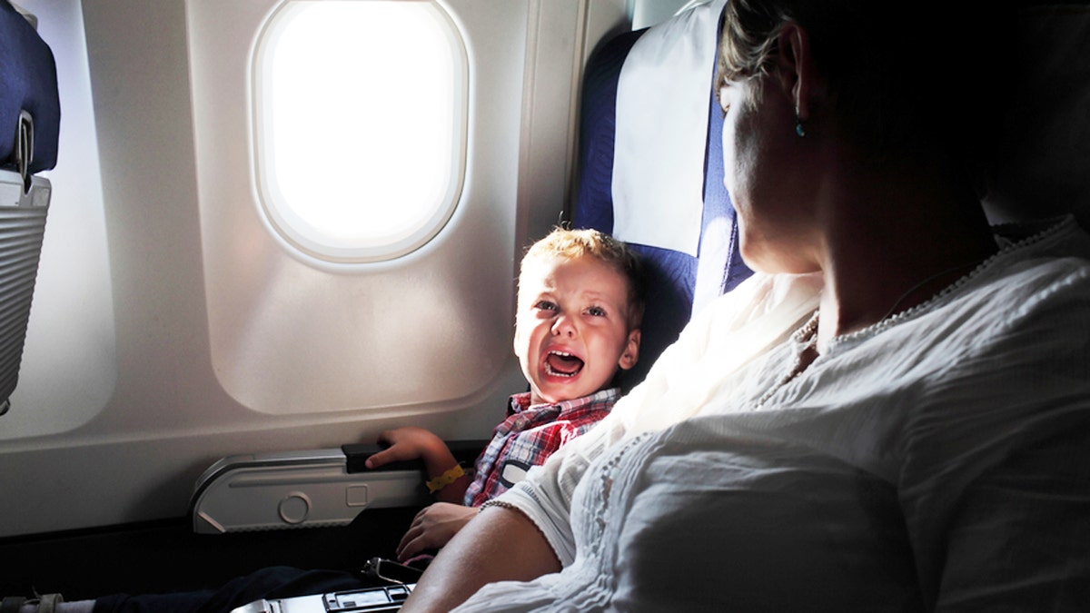 Portrait of the crying boy on the flight