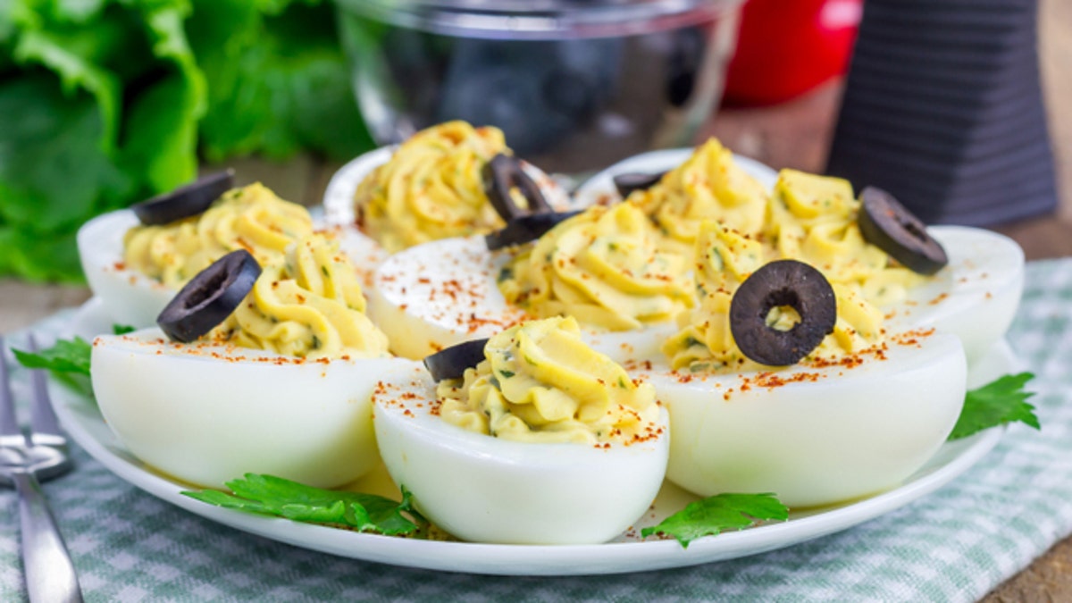 Spicy deviled eggs garnished with olives