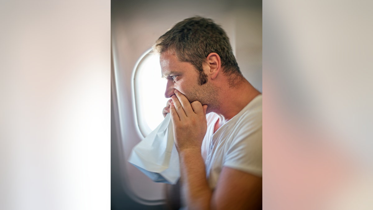 Airsickness. Man feels very bad on the plane.