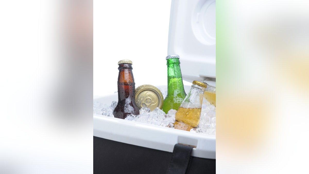 Assorted Beer Bottles and Cans in Cooler