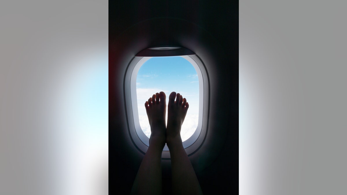 feet touched the airplane window