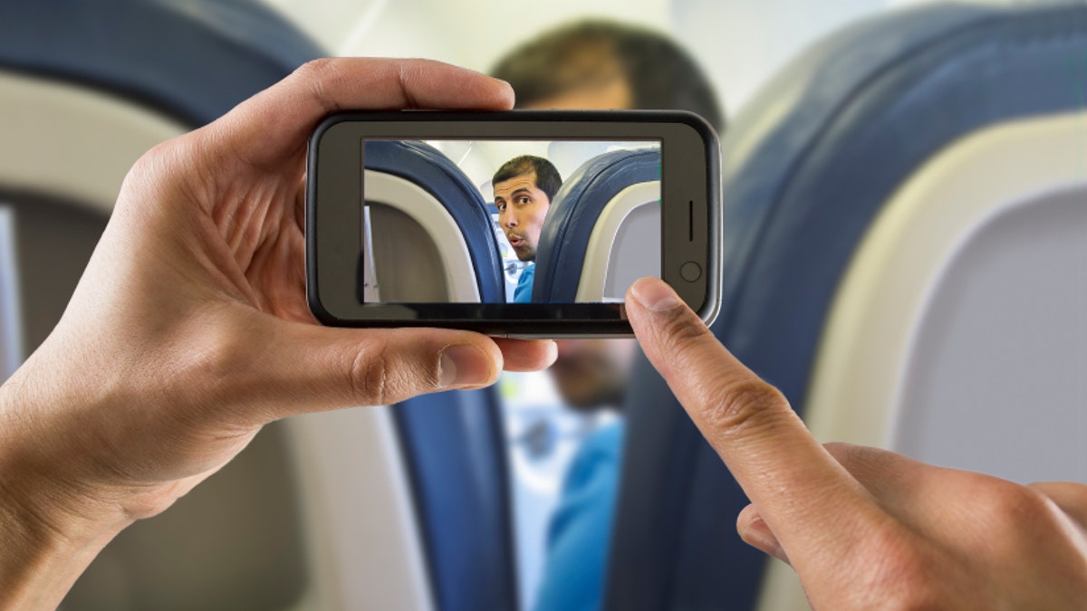 photographing a surprised man on a plane
