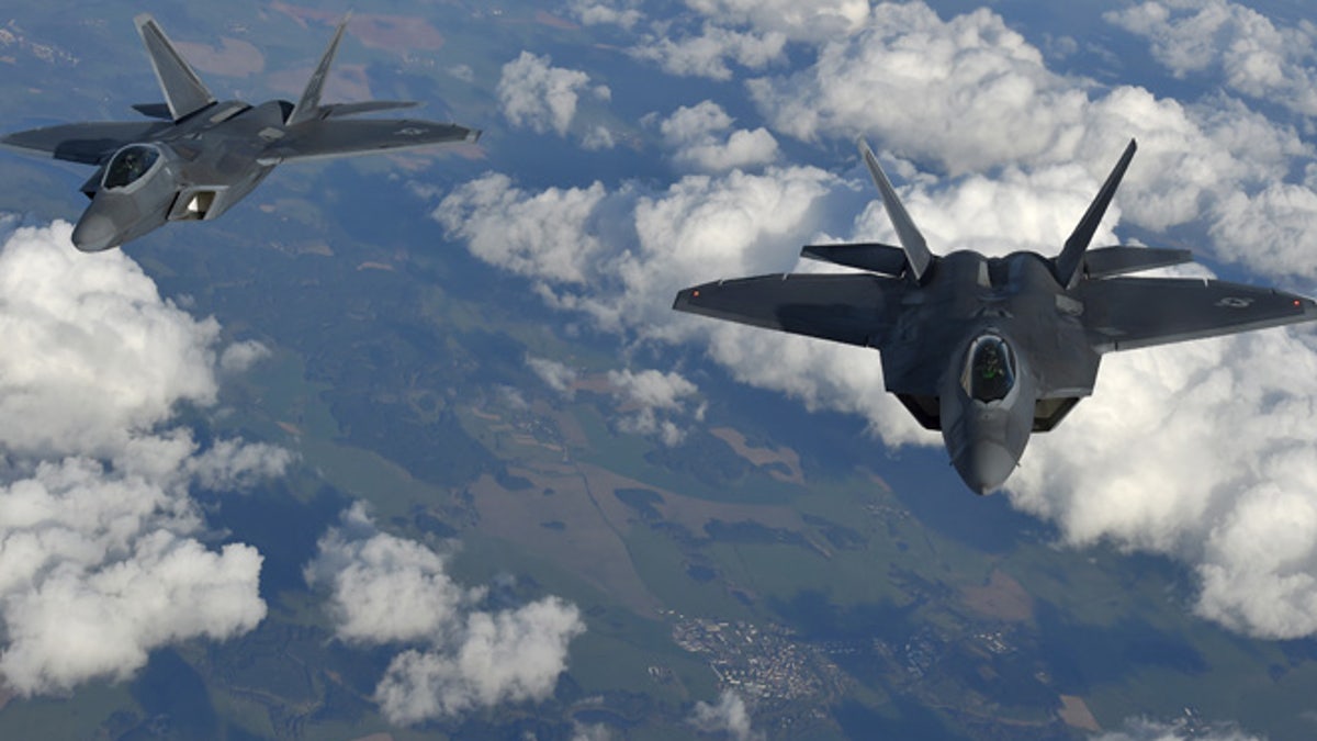Two U.S. F-22 Raptor fighters fly over European airspace during a flight to Britain from Mihail Kogalniceanu air base in Romania April 25, 2016. REUTERS/Toby Melville - RTX2BM2B