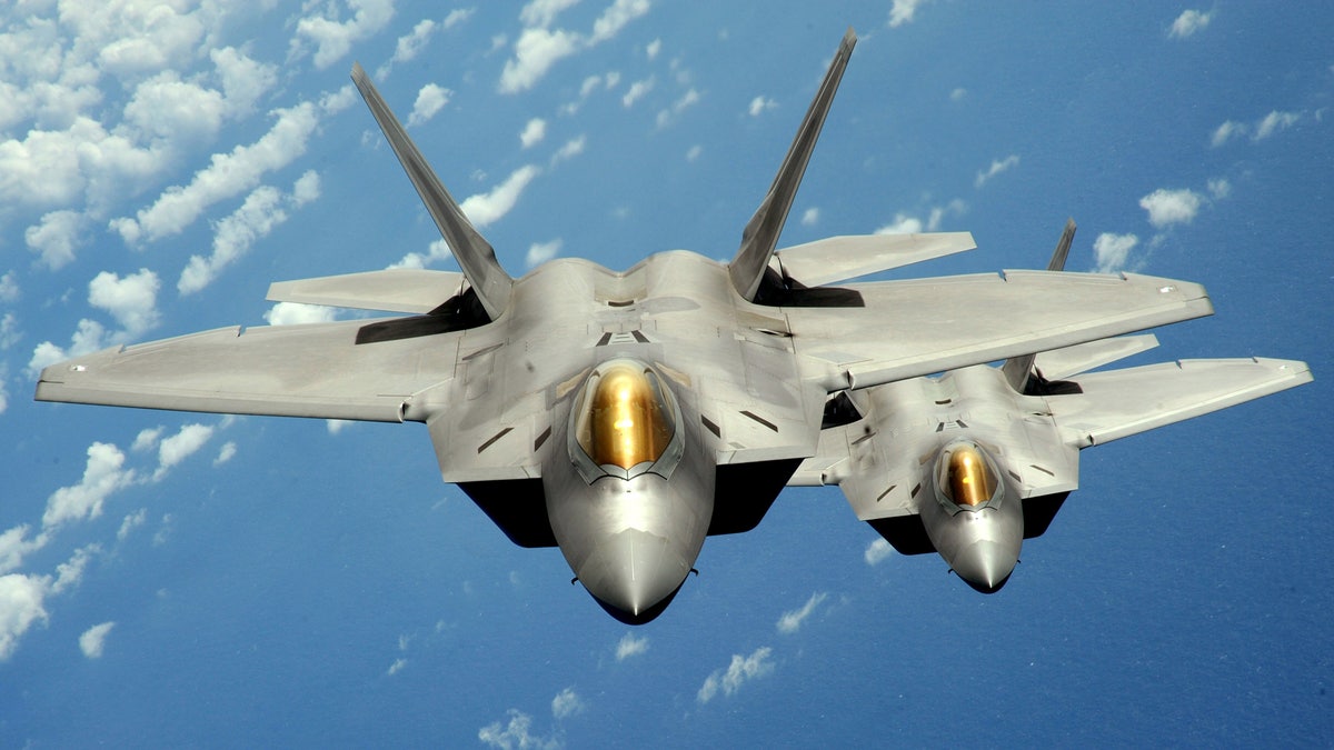 Two U.S. Air Force F-22 Raptor stealth jet fighters fly near Andersen Air Force Base in this handout photo dated August 4, 2010. China is still years away from being able to field a stealth aircraft, despite the disclosure of images indicating that it appears to have a working prototype, Pentagon officials said on Wednesday. A U.S. intelligence official estimated in May that the J-20 could rival the F-22 Raptor within eight years. The Raptor is the premier U.S. fighter, with cutting-edge 