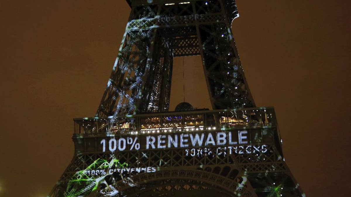 FILE- In this Sunday, Nov. 29, 2015 file photo, an artwork entitled 'One Heart One Tree' by artist Naziha Mestaoui is displayed on the Eiffel tower ahead of the 2015 Paris Climate Conference, in Paris.  The Paris Agreement on climate change comes into force Friday Nov. 4, 2016, after a year with remarkable success in international efforts to slash man-made emissions of carbon dioxide and other global warming gases. (AP Photo/Thibault Camus, FILE)