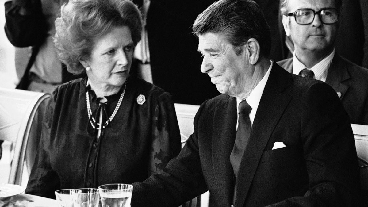 FILE - This is a Sunday, June 6, 1982 file photo of U.S. President Ronald Reagan and Britain's Prime Minister Margaret Thatcher at the lunch table, Sunday, June 6, 1982 at the Palace of Versailles, France, following the first session of the second days summit meeting. Margaret Thatcher felt betrayed by close ally Ronald Reagan over the Falkland Islands, according to newly released papers that reveal how isolated Britain's prime minister was in her determination to repel the Argentine invasion by force. When Argentina seized the British territory off the South American coast in April 1982, Thatcher's government presented a united front in public.(AP Photo/ File)