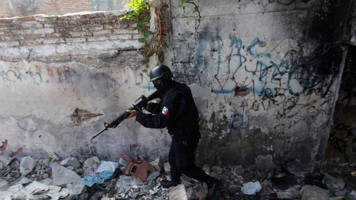 ADVANCE FOR USE SUNDAY, JUNE 5, 2011 AND THEREAFTER - In this Wednesday, April 6, 2011 picture, a state police officer belonging to a newly-formed elite group participates in a patrol during a preventive surprise search at a low-income neighborhood in the Pacific resort city of Mazatlan, Mexico. The so-called Elite Group has been deployed to hotspots around Sinaloa state, dismantling neighborhood gangs in the port city of Mazatlan and making significant arrests, according to local officials. Sinaloa, which shares a name with Mexico's most powerful drug cartel, is known as the cradle of drug trafficking in the country. (AP Photo/Dario Lopez-Mills)