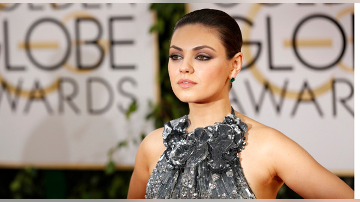 Actress Mila Kunis arrives at the 71st annual Golden Globe Awards in Beverly Hills, California January 12, 2014. REUTERS/Mario Anzuoni (UNITED STATES - Tags: Entertainment)(GOLDENGLOBES-ARRIVALS) - RTX17BFE