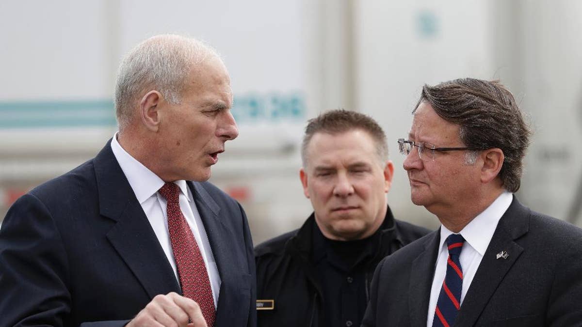 Homeland Security Secretary John Kelly, left, talks with Sen. Gary Peters D-Mich., before a news conference at the Ambassador Bridge border crossing, Monday, March 27, 2017, in Detroit. Kelly observed northern border operations and met with DHS personnel, local immigration stakeholders and Arab American community members. (AP Photo/Carlos Osorio)