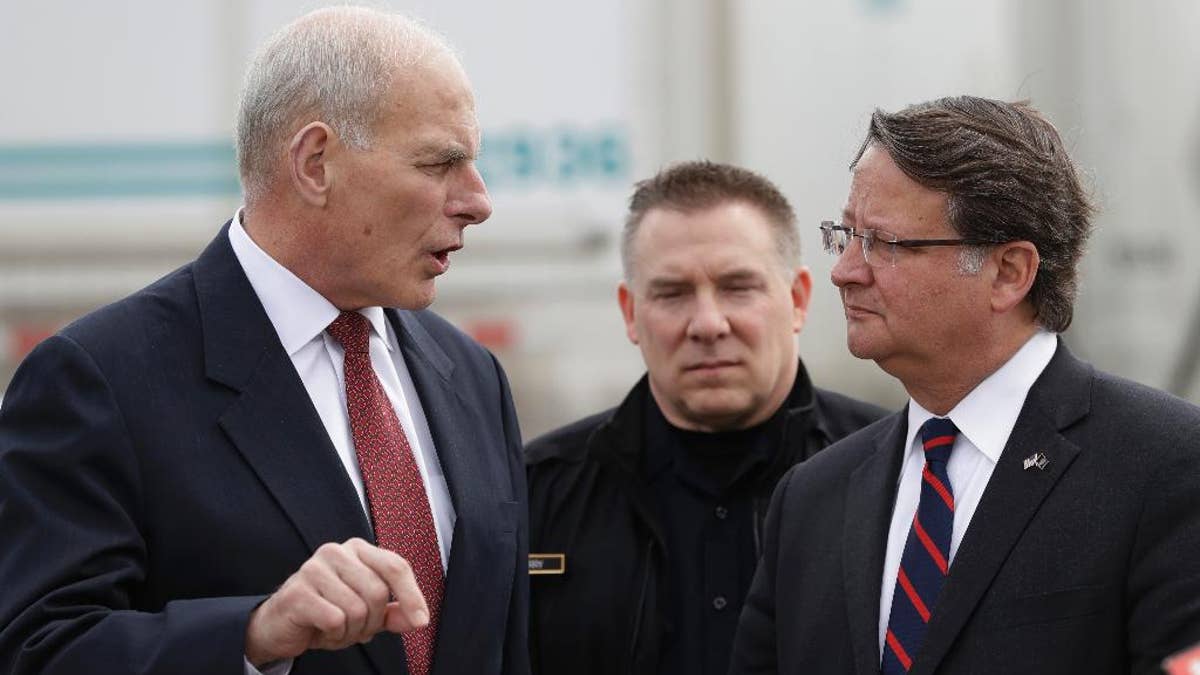 Homeland Security Secretary John Kelly, left, talks with Sen. Gary Peters D-Mich., before a news conference at the Ambassador Bridge border crossing, Monday, March 27, 2017, in Detroit. Kelly observed northern border operations and met with DHS personnel, local immigration stakeholders and Arab American community members. (AP Photo/Carlos Osorio)