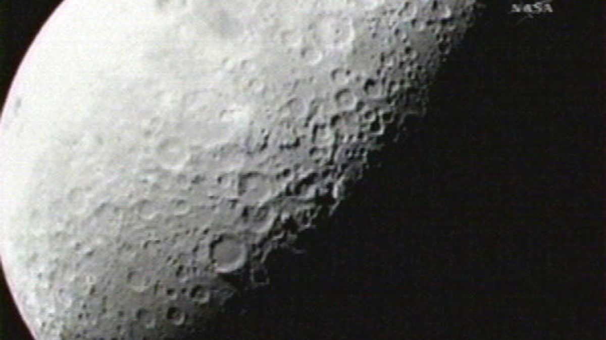 This image provided by NASA shows the first image taken of the moon from the Lunar Crater Observation and Sensing Satellite Friday morning Oct. 9, 2009. Two NASA spacecraft are barreling toward the moon at twice the speed of a bullet, about to crash into a lunar crater in a search for ice. (AP Photo/NASA)