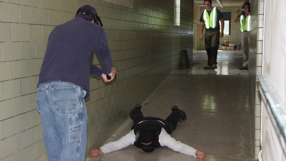 Teachers practice for an active shooter scenario in an Ohio school.