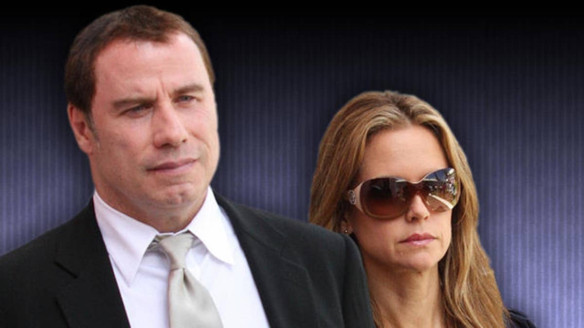 U.S. actor John Travolta and wife Kelly Preston leave the court building in Nassau, Bahamas, Wednesday, Sept. 23, 2009. Travolta described the moments before his son's death in the Bahamas as he testified Wednesday against two people accused of trying to blackmail him with private information about the rescue effort. (AP Photo/Kris Ingraham)
