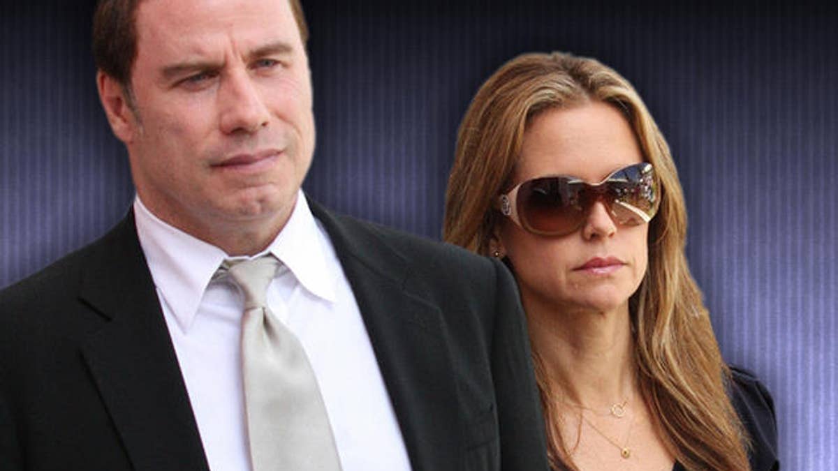 U.S. actor John Travolta and wife Kelly Preston leave the court building in Nassau, Bahamas, Wednesday, Sept. 23, 2009. Travolta described the moments before his son's death in the Bahamas as he testified Wednesday against two people accused of trying to blackmail him with private information about the rescue effort. (AP Photo/Kris Ingraham)