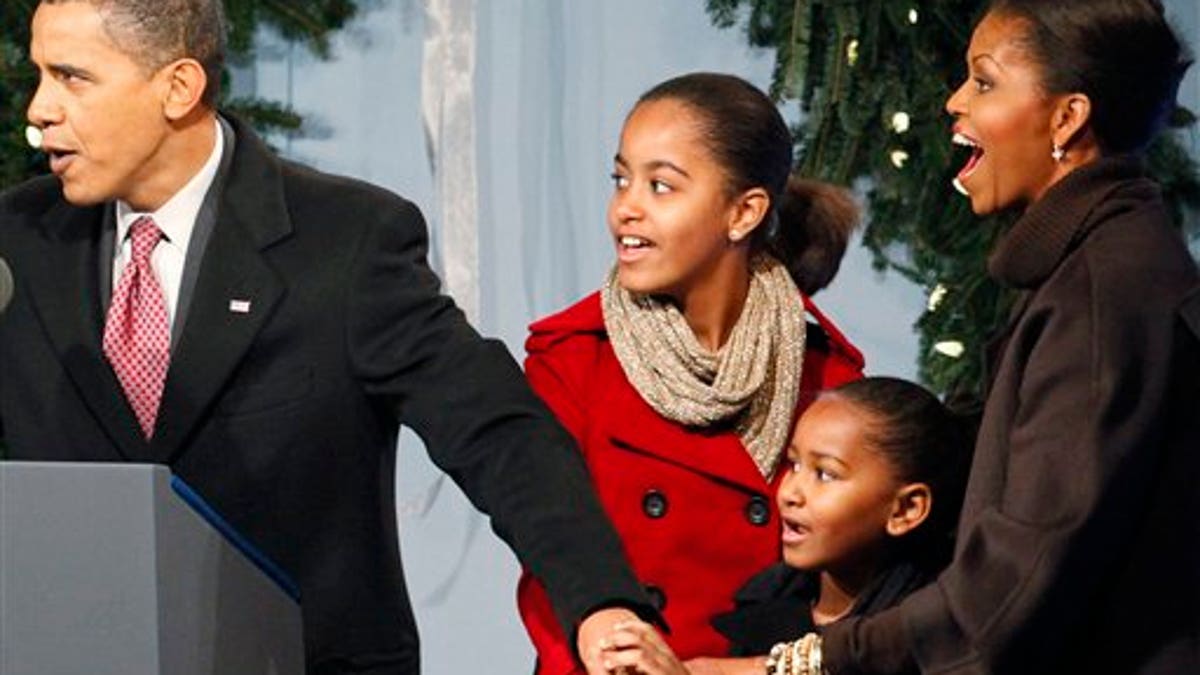 President Barack Obama, first lady Michelle Obama and daughters Sasha and Malia help to light the National Christmas Tree, Thursday, Dec. 3, 2009, in Washington. (AP Photo/Haraz N. Ghanbari)