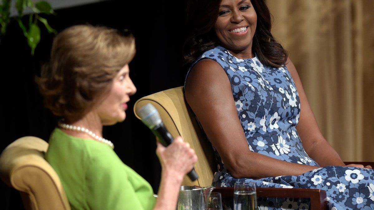First lady Michelle Obama listens as former first lady Laura Bush speaks during the "America's First Ladies: In Service to Our Nation" conference at the National Archives in Washington, Friday, Sept. 16, 2016. (AP Photo/Susan Walsh)