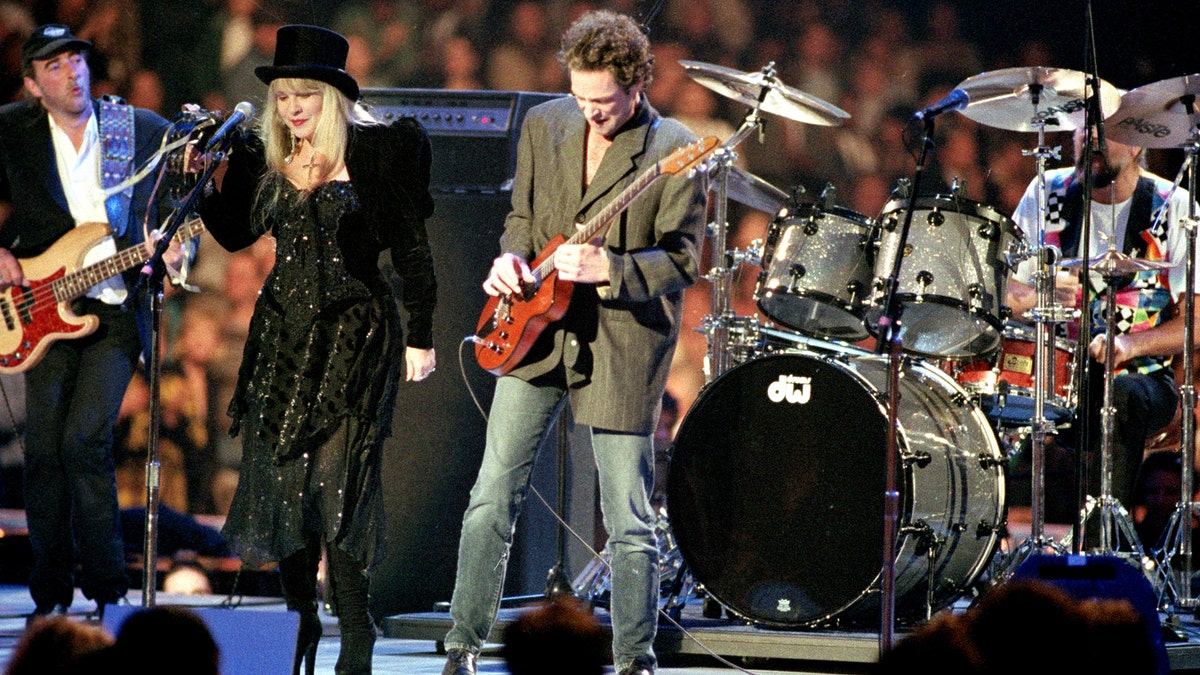 FILE - In a Monday, Jan. 18, 1993 file photo, the rock group Fleetwood Mac, reuniting after 13 years apart, performs during the American Gala evening at the Capital Centre in Landover, Md.   From left to right are, John McVie, Stevie Nicks, Lindsey Buckingham and Mick Fleetwood. Fleetwood Mac annunced Sunday, Oct. 27, 2013 that the group is canceling planned performances in Australia and New Zealand as bassist John McVie is treated for cancer. (AP Photo/Amy Sancetta, File)