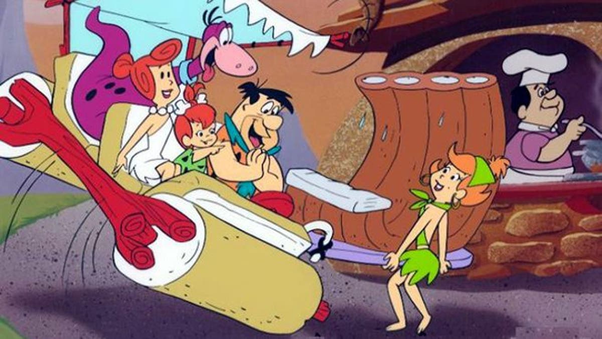 Fred Flintstone and family prepare to feast on broiled brontosaurus ribs.