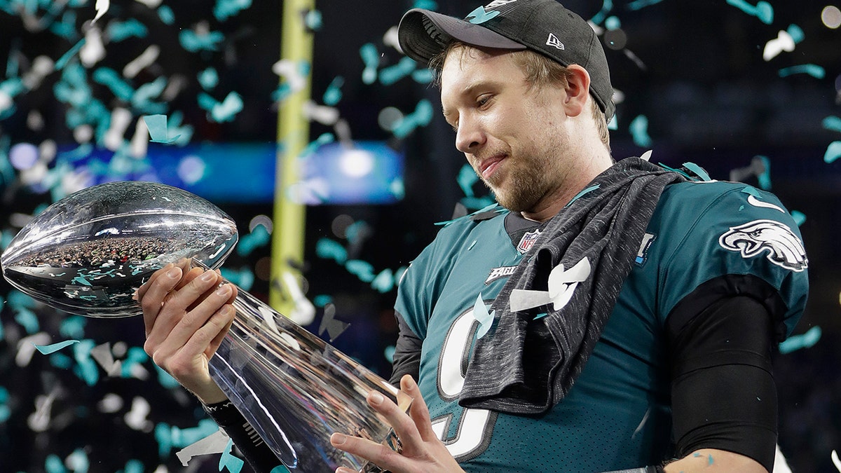 Philadelphia Eagles' Nick Foles holds up the Vince Lombardi Trophy after the NFL Super Bowl 52 football game against the New England Patriots, Sunday, Feb. 4, 2018, in Minneapolis.
