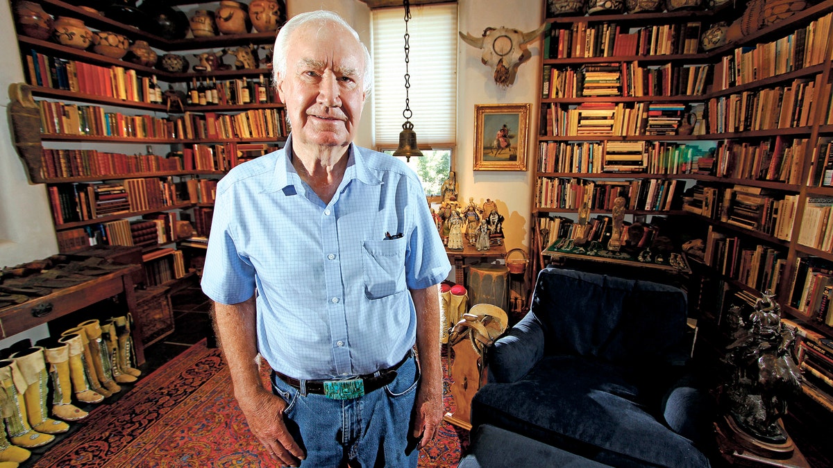 In this July 4, 2014 photo, Forrest Fenn poses at his Santa Fe, N.M., home. New Mexico's top law enforcement officer is asking Fenn, the author and antiquities dealer who inspired thousands to comb remote corners of the West in vain for a chest of gold and jewels to end the treasure hunt. The plea from New Mexico State Police Chief Pete Kassetas follows what authorities believe is the latest death related to the hunt for Fenn's hidden treasure. (Luis Sanchez Saturno/Santa Fe New Mexican via AP)